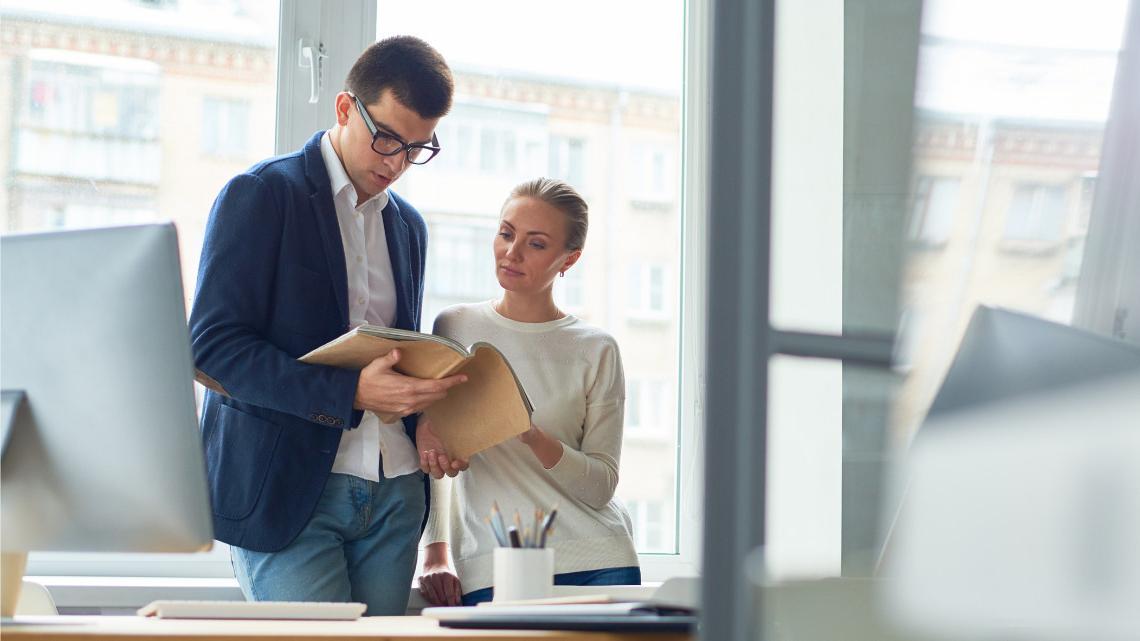 Employees reviewing an employee handbook